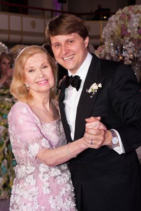 Tricia Nixon Cox smiling while dancing with her son Christopher Nixon Cox