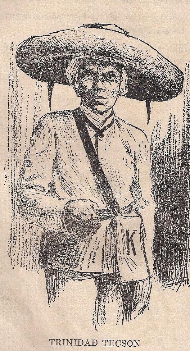 Portrait of Trinidad Tecson carrying a bag with the letter K and seriously looking at something while wearing a buri hat, long sleeve blouse, and pants.
