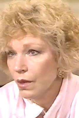 Truddi Chase speaking in an interview and wearing a white dress.