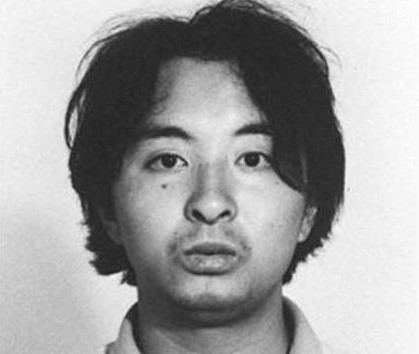 Tsutomu Miyazaki with a mole on his face and long black hair.