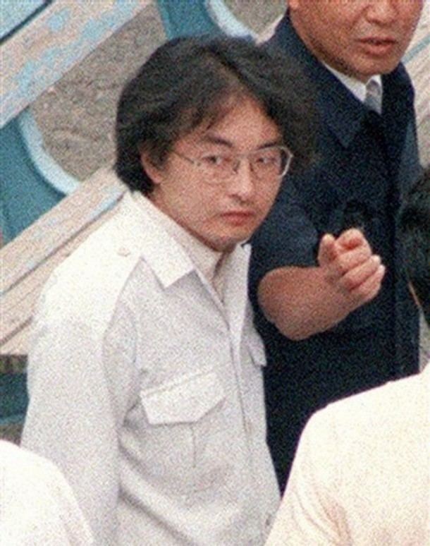 Tsutomu Miyazaki wearing eyeglasses and white long sleeves.