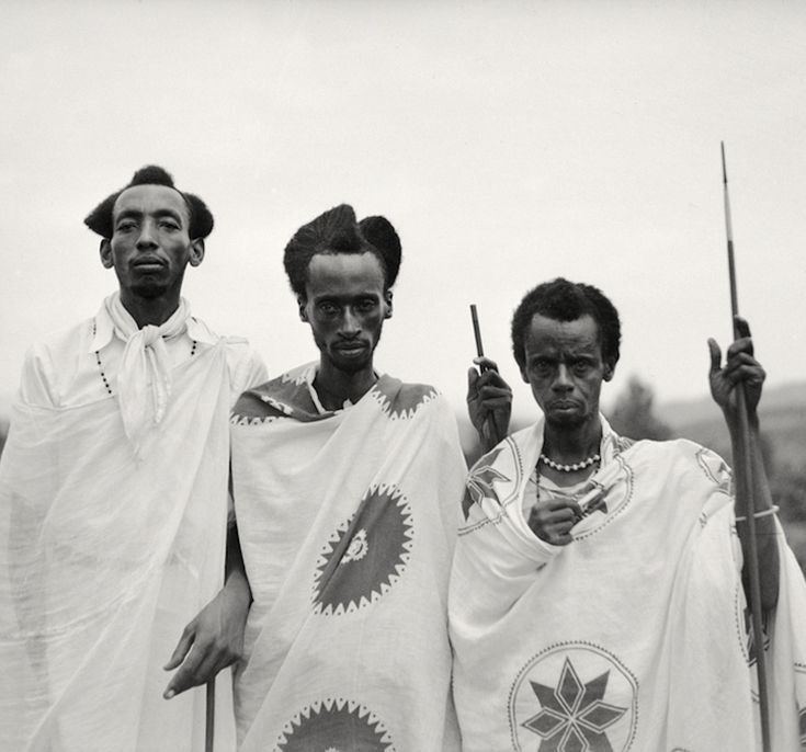 The Tutsi, an ethnic group of the African Great Lakes Region wearing all white and holding a stick.