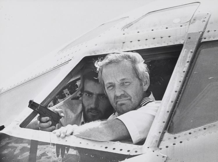 TWA Flight 847 Captain John Testrake talks to newsmen from the cockpit of his