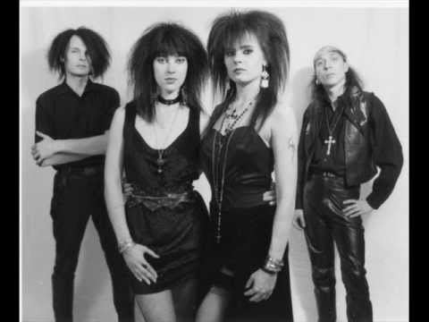 Anne Nurmi and Nauku (center) of Two Witches along with their two other bandmates. Anne Nurmi and Nauku with a fierce look while wearing a dress, necklace, bracelet, and earrings