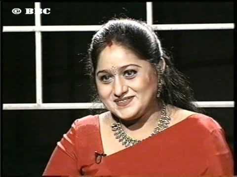 Uma Maheswari wearing red dress and necklace in her Face to Face interview