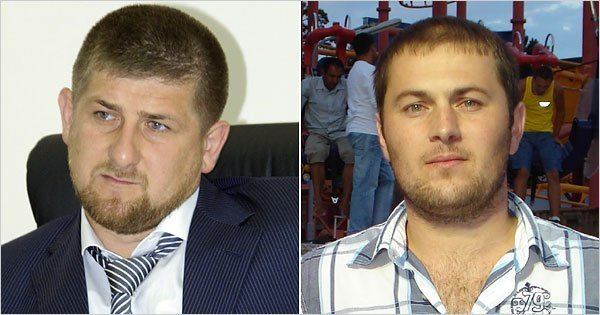 Ramzan Kadyrov looking serious with a beard and mustache and wearing a white shirt under a blue coat with a black and white necktie (on the left) and Umar Israilov looking serious having a beard and mustache with people in the background while wearing a checkered shirt (on the right)