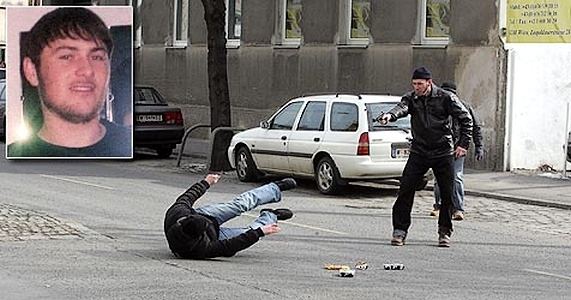 Umar Israilov falling to the ground after getting shot by some men in black