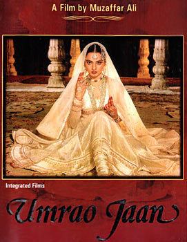 Rekha sitting on the ground with a fierce look while wearing a beige dress and a veil in a poster of the 1981 film "Umrao Jaan"