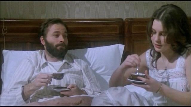 Franco Nero as Guido and Lara Wendel as Mimmina having a cup of tea in a scene from the 1979 movie "Un dramma borghese"