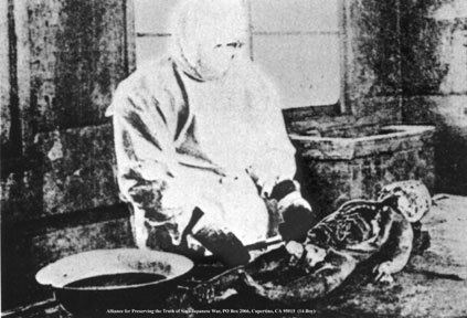A person wearing a mask and laboratory suit is experimenting dead child's body.