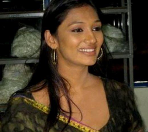 Upeksha Swarnamali smiling at something and wearing a dark green dress.