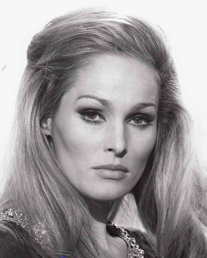 Ursula Andress posing for a black and white paperback pictorial with her hair drawn back.