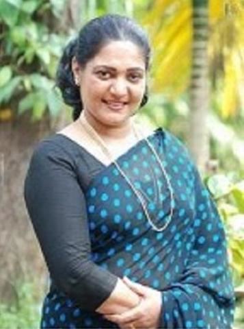 Usha (actress) wearing a black and white polka-dotted dress, gold earrings, and necklace