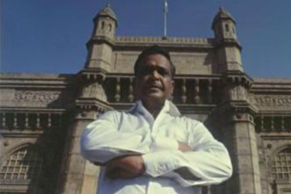 Varadarajan Mudaliar' arms crossed while wearing white long sleeves