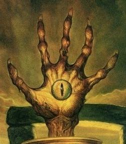 A desiccated left hand of Vecna with long nails and her left eye in the middle glowing in yellow effect.