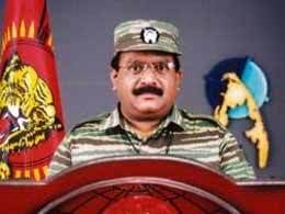 Velupillai Prabhakaran standing in a rostrum wearing his uniform