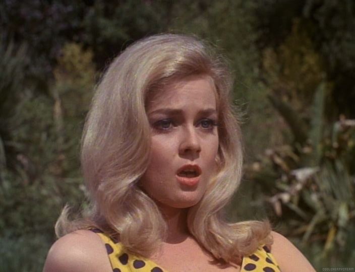 Venita Wolf as Brenda with a worried facial expression and wearing a spotted yellow bathing suit in a scene from The Monkees, 1966.