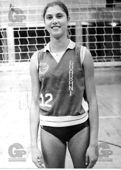 Vera Mossa smiling while wearing a sleeveless jersey with the number twelve on the left side and black panty