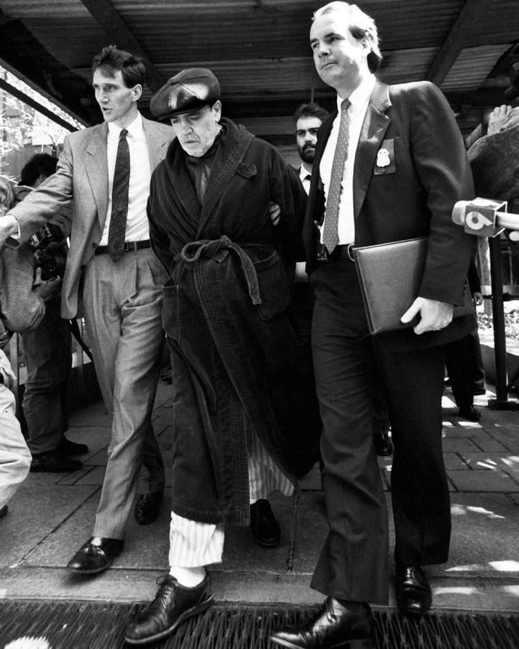 Vincent Gigante accompanied by two men while wearing a bathrobe and hat