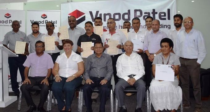 Front from left are Director Pravin General Manager- HRD & CS Patel, Ranju Kumar, Director Umakant Patel, Director Jayanti Patel, staff and recipient Lavenia Burelevu and standing at the back are recipients of the Life Insurance policy with board directors