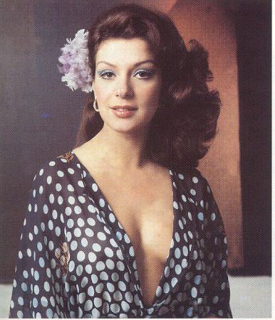 Virginia Vallejo wearing a sexy polka dot blouse and a flower on her hair