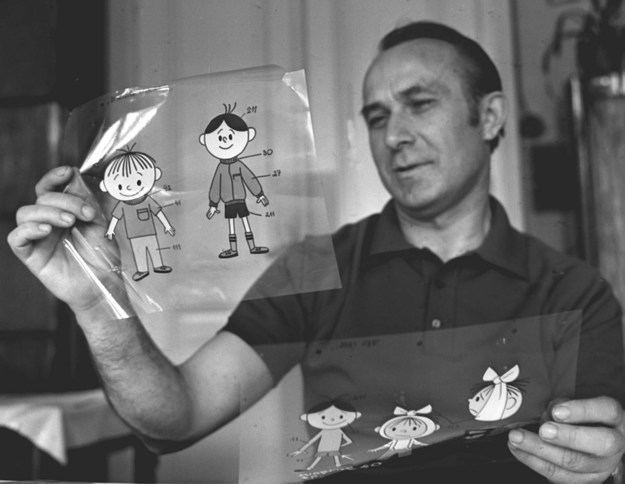 Wladyslaw Nehrebecki holding his animator characters, Bolek and Lolek