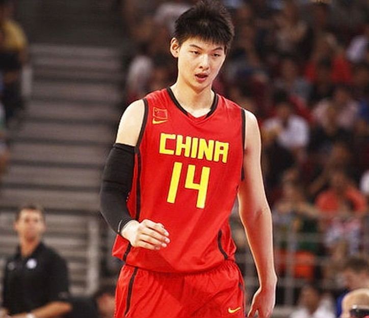 Wang Zhelin in a basketball court while wearing black arm sleeves and a black and red jersey with number 14