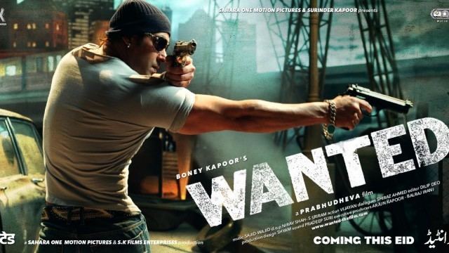 Salman Khan holding a gun while wearing black shades, a black beanie, and a gray t-shirt in the 2009 film Wanted