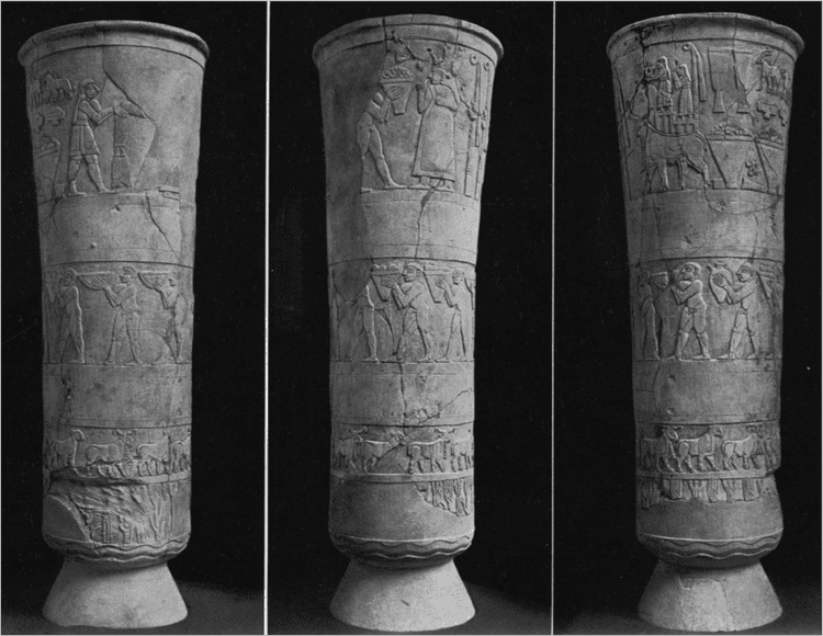 Warka Vases, a slim carved alabaster vessel.