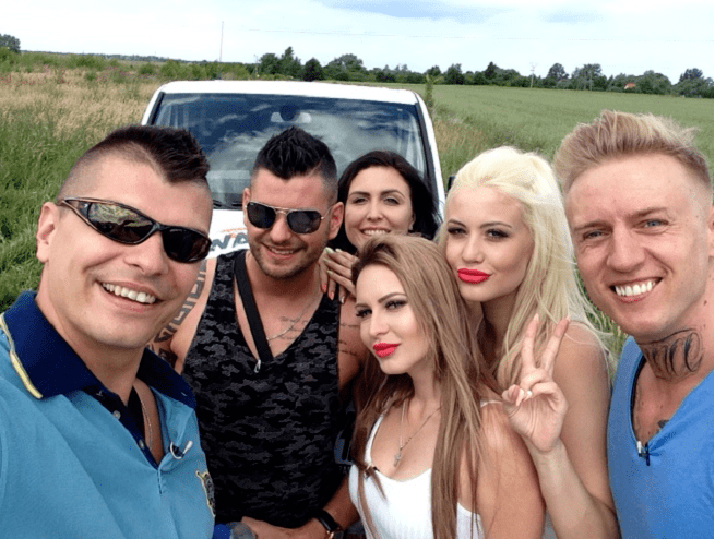 The cast of Warsaw Shore smiling all together while they are at the rice field