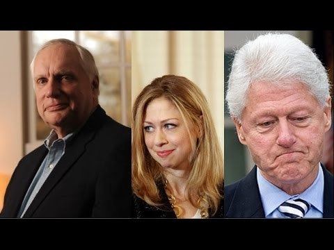 Webster Hubbell, Chelsea Clinton, and Bill Clinton (from left to right). Webster smiling with white hair wearing a light blue collared shirt and a black coat. Chelsea smiling and looking at her side with blonde hair and wearing a gold necklace, an white inner blouse under a black coat. Bill in serious face looking down at something with white hair wearing a black and white stripes necktie, blue collared shirt, and a black coat.