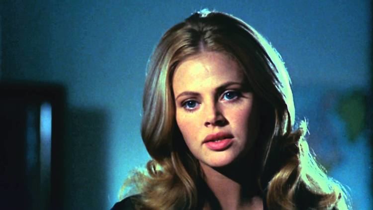 Britt Ekland with a serious face and wavy hair in a scene from the 1971 horror film, What the Peeper Saw