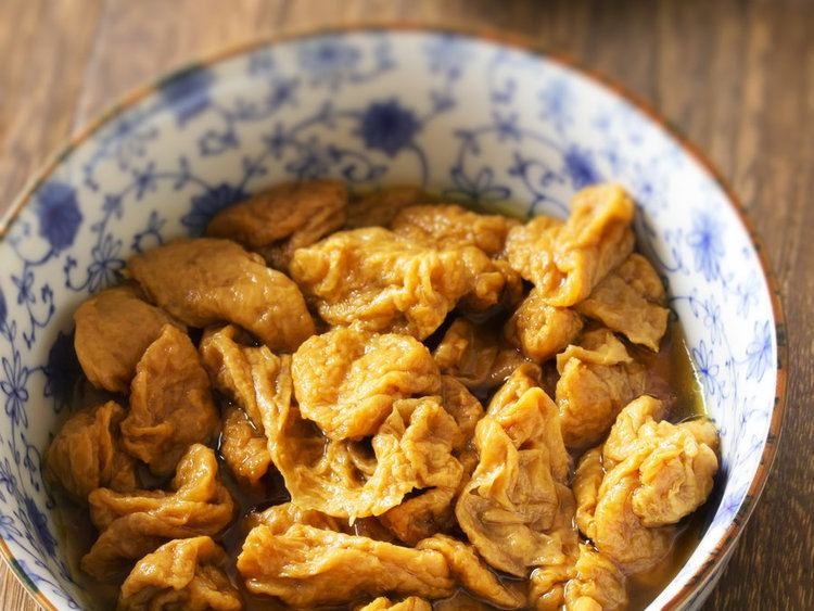 Seitan, a food made from gluten, being prepared for cooking inside a bowl.