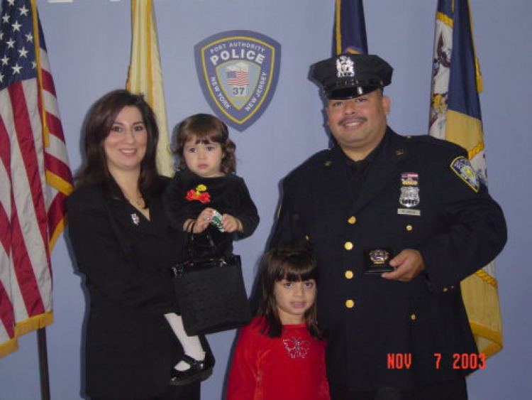 Will Jimeno wearing his uniform with his wife Allison Jimeno wearing a black suit together with their daughters.