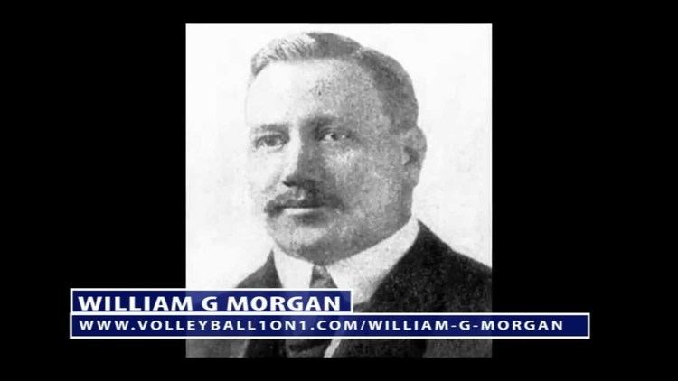 William G. Morgan with mustache while wearing a black coat, white long sleeves, and necktie