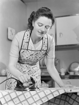 Woman Ironing Woman ironing in the kitchen late 1940s at Science and Society