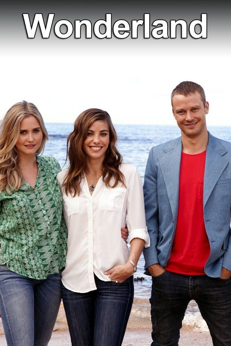 Anna Bamford, Brooke Satchwell, and Michael Dorman are smiling. Anna wearing a green top and blue jeans, Brooke wearing a white long sleeve top and blue jeans while Michael wearing a blue coat over a red shirt and black jeans.