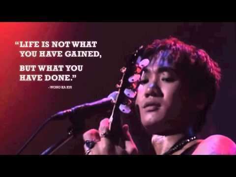 Poster with inspiring words by Wong Ka Kui with a serious face while playing guitar.