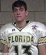 Wyatt Sexton is serious and has brown hair, he is wearing a white padded jersey with black and yellow stripes with the number 13 at the center and “FLORIDA” printed on his jersey.