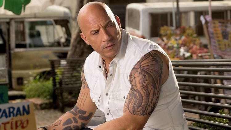 Vin Diesel wearing white sleeveless polo in a scene from the 2017 movie, XXX: Return of Xander Cage