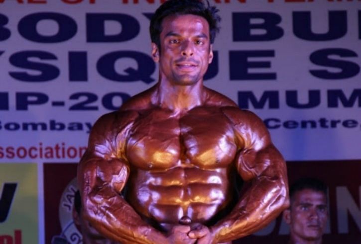 Yatinder Singh showing his muscular body