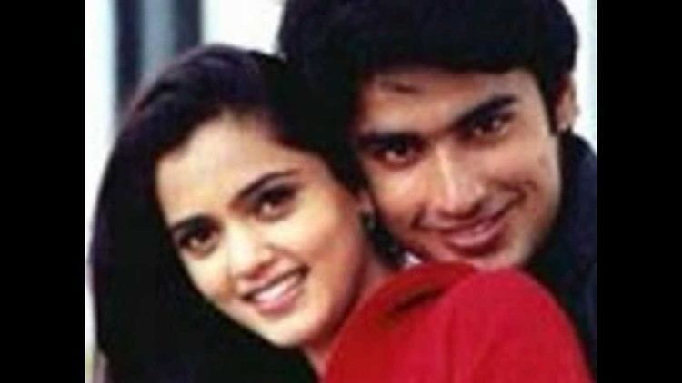 Jividha Sharma smiling while wearing a red blouse while Karann Nathh wearing black polo