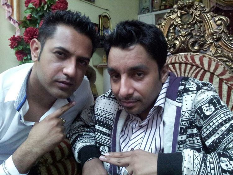 Gippy Grewal wearing white long sleeves and Yudhvir Manak in his black and white jacket and striped long sleeves