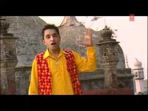 Yudhvir Manak singing while wearing yellow long sleeves and vest