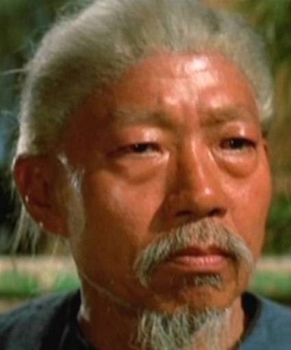 Yuen Siu-tien with a serious face, with pony-tailed white hair, a white mustache, and a white beard.