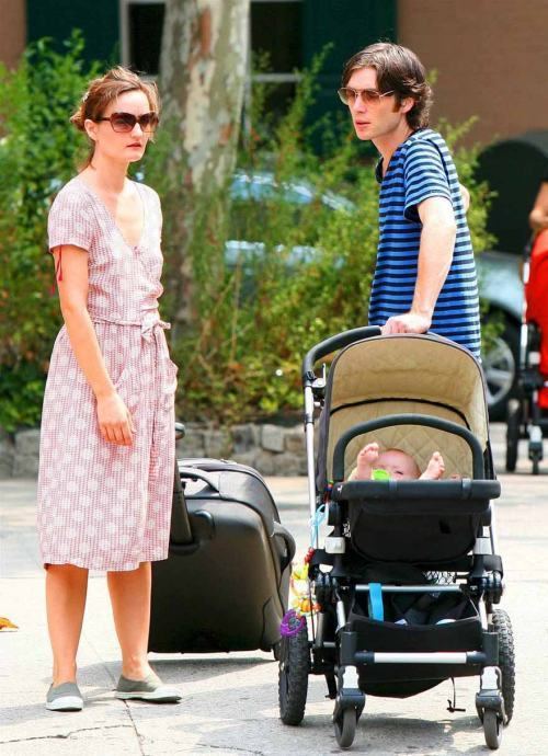 Yvonne McGuinness holding her suitcase and Cillian Murphy holding the stroller with a baby