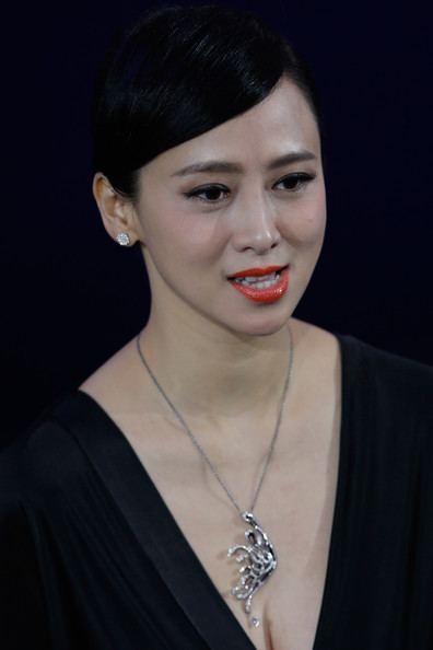 Yvonne Yung smiling with her hair neatly arranged and wearing a black dress and a silver necklace.