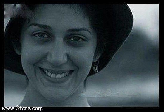 Zahra Amir Ebrahimi smiling and wearing earrings, and a black hat