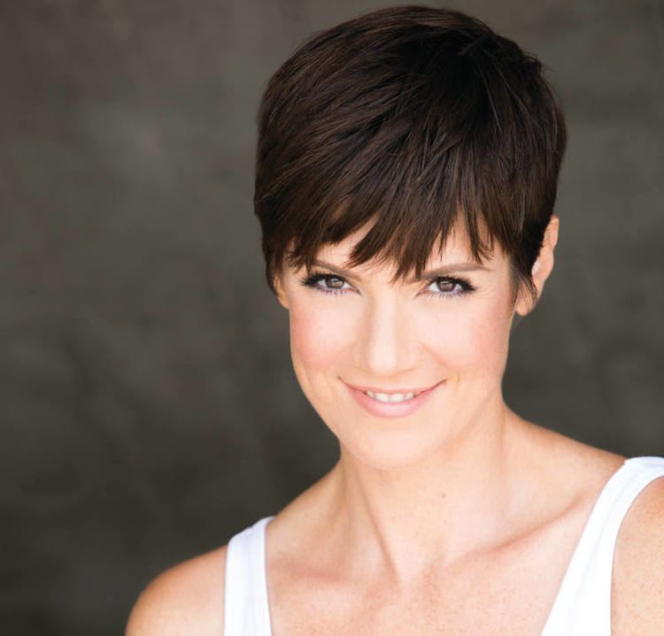 Zoe McLellan smiling while wearing white top