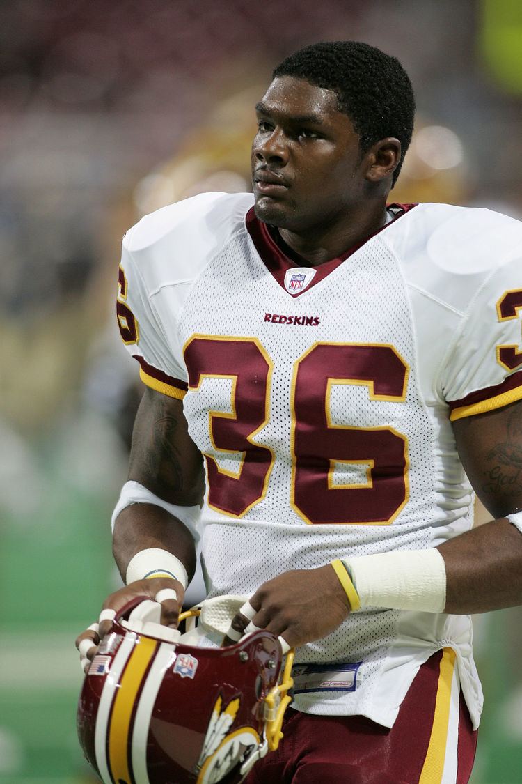 Sean Taylor with a serious face and wearing a football uniform.